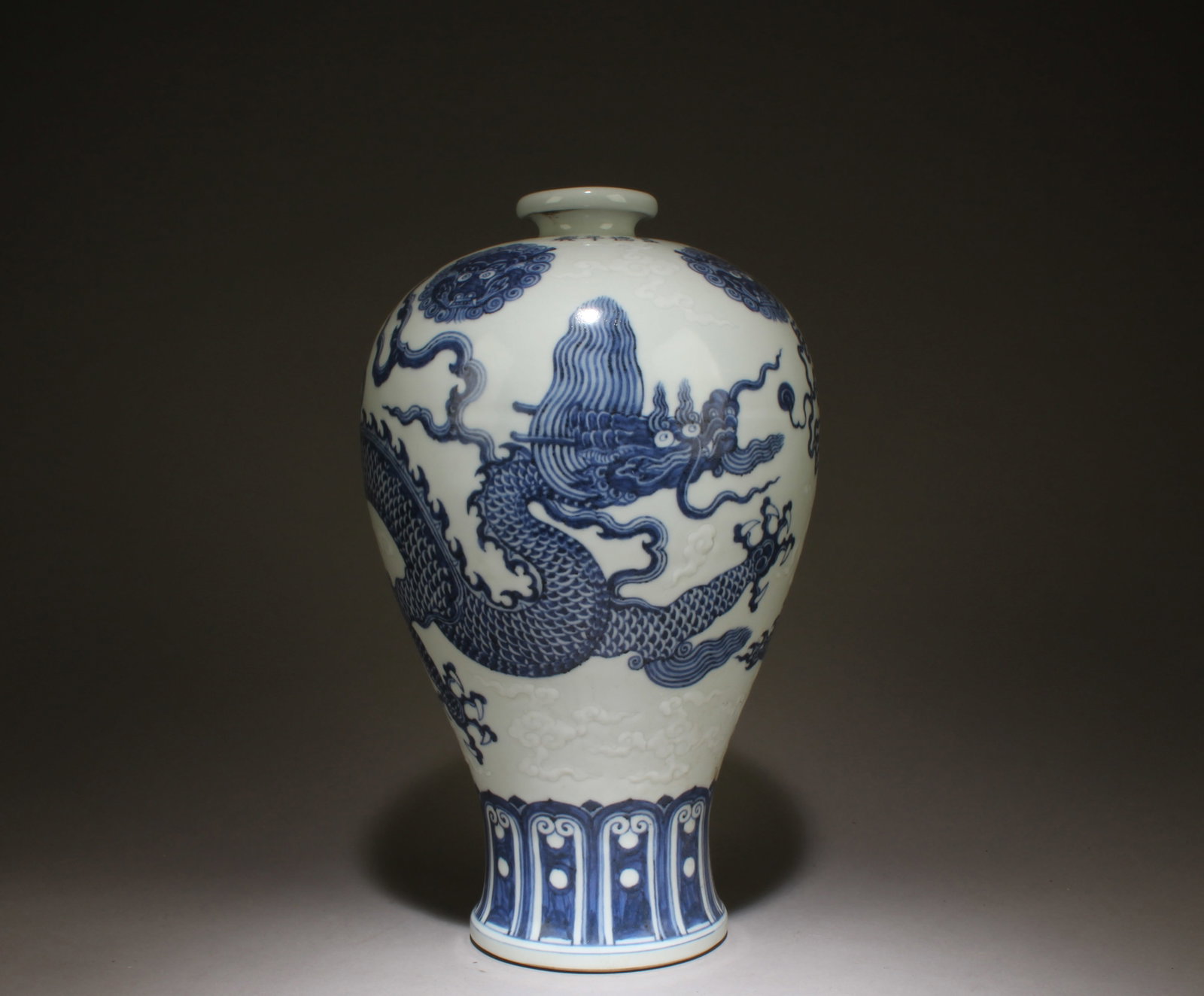A Blue and White Dragon Design Vase: A Blue and White Dragon Design Vase. Dimensions: 12" x 7.5".