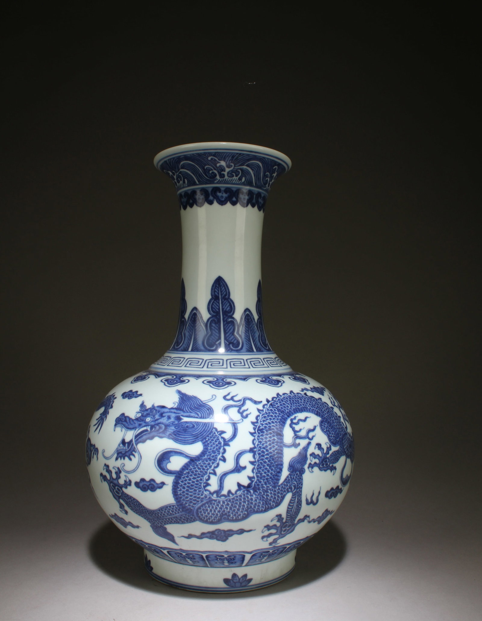 A Blue and White Dragon Design Vase: A Blue and White Dragon Design Vase. Dimensions: 14.5" x 9.25".