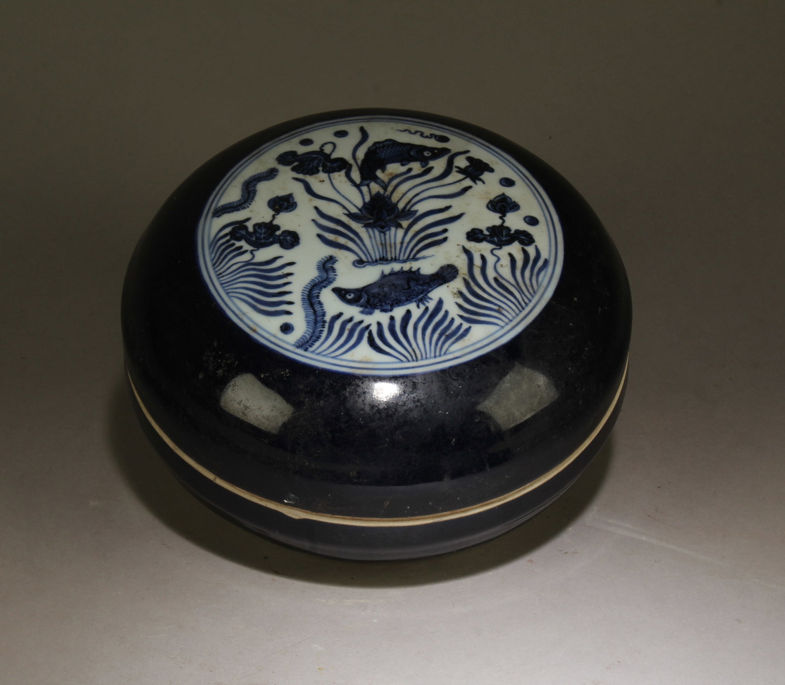 A Blue and White Container: A Blue and White Container. Dimensions: 5" x 8.5".