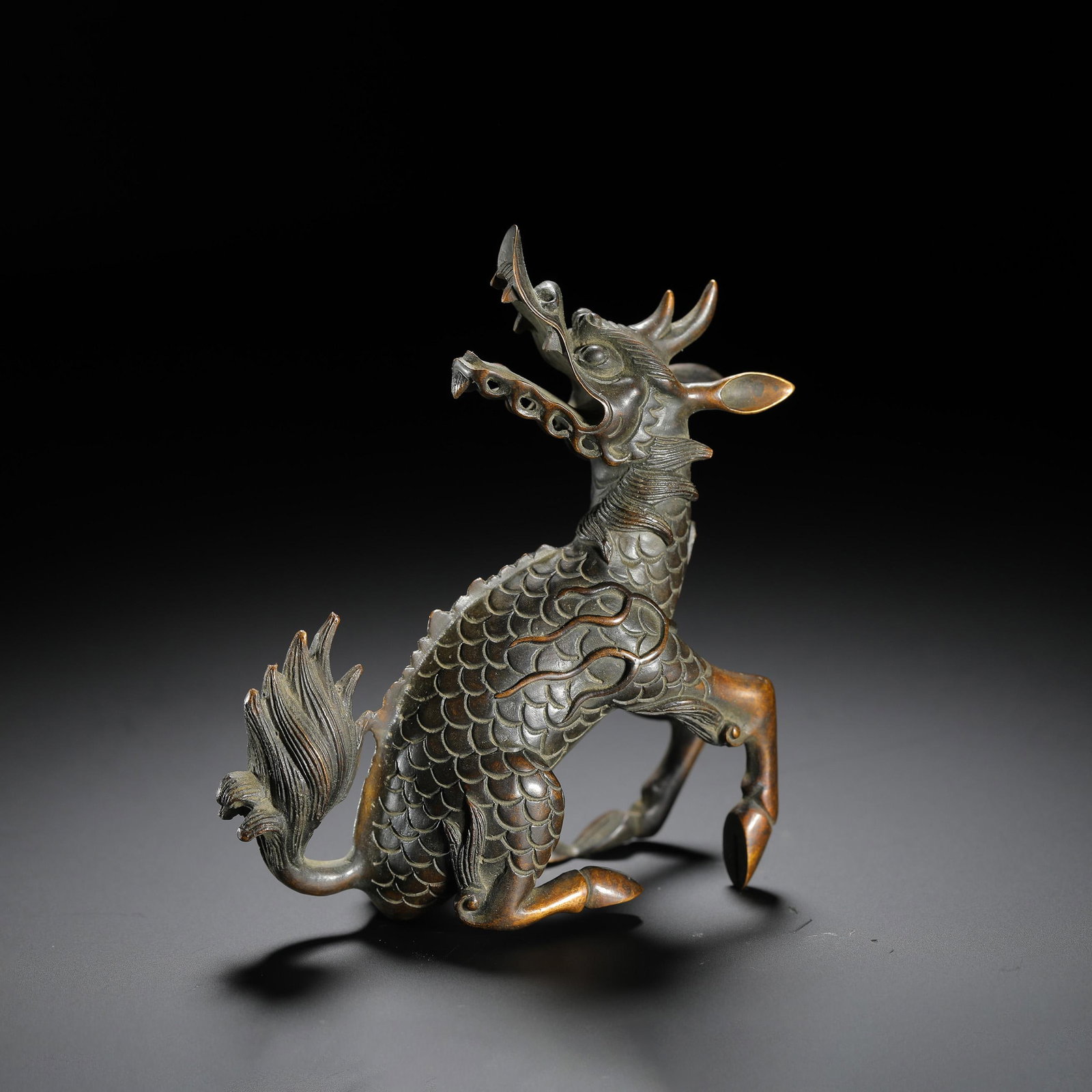 Bronze Hou Defying Heaven Qilin Ornament: Bronze Hou Defying Heaven Qilin Ornament. Length:3.94" Width:1.50" Height:4.21"