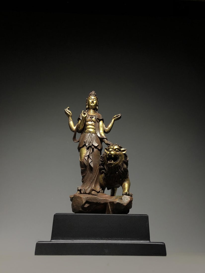A Gilt Bronze Manjushri Statue: A Gilt Bronze Manjushri Statue. Height: 11.81"; Dimensions: 5.12" x 3.94" x 9.65". Weight: 7.94lbs.