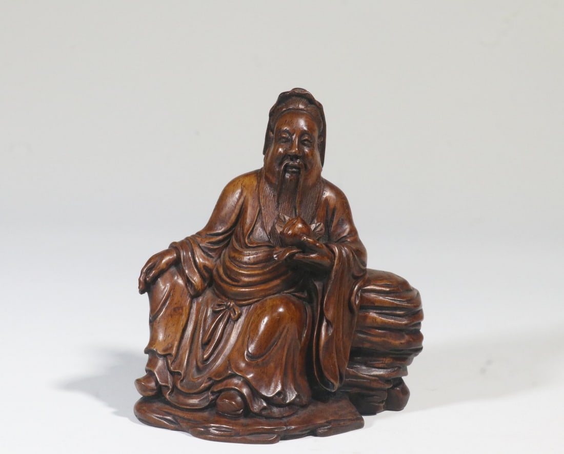 A Huanghuali Wood Figure: A Huanghuali Wood Figure. Height: 4.09"; Length: 3.82"; Width: 2.36". Weight: 0.31lbs.