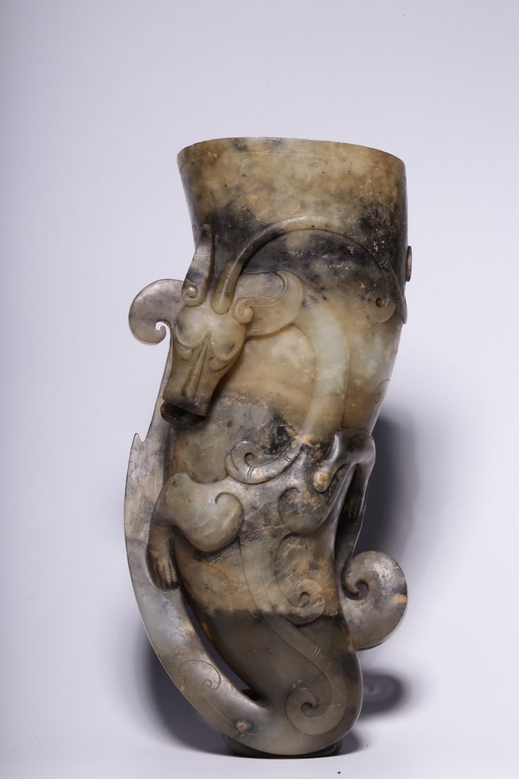An Archaic Jade Cup: An Archaic Jade Cup. Height: 7.87"; Length: 3.94"; Width: 2.76". Weight: 1.49lbs.