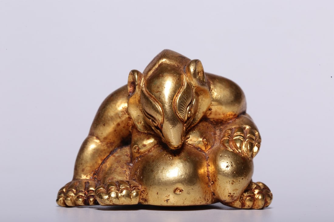 A Gilt Bronze Paperweight: A Gilt Bronze Paperweight. Height: 1.38"; Length: 2.36"; Width: 1.46". Weight: 0.69lbs.