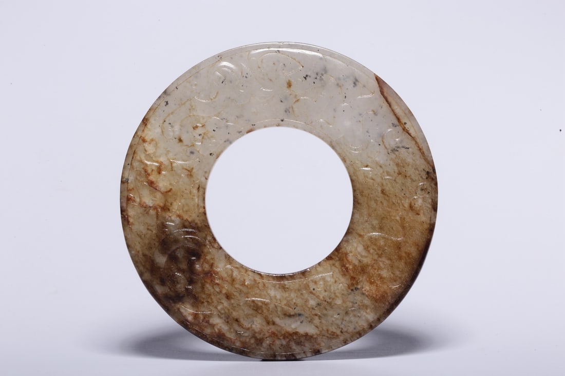 A Hetian Jade Bi Disc: A Hetian Jade Bi Disc. Diameter: 3.35"; Thickness: 0.16". Weight: 0.14lbs.