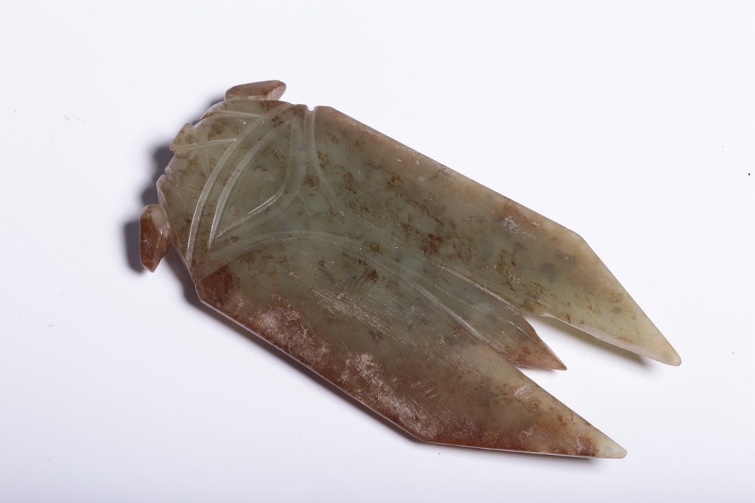 A Hetian Jade Cicada: A Hetian Jade Cicada. Dimensions: 2.83" x 1.30" x 0.39". Weight: 0.07lbs.