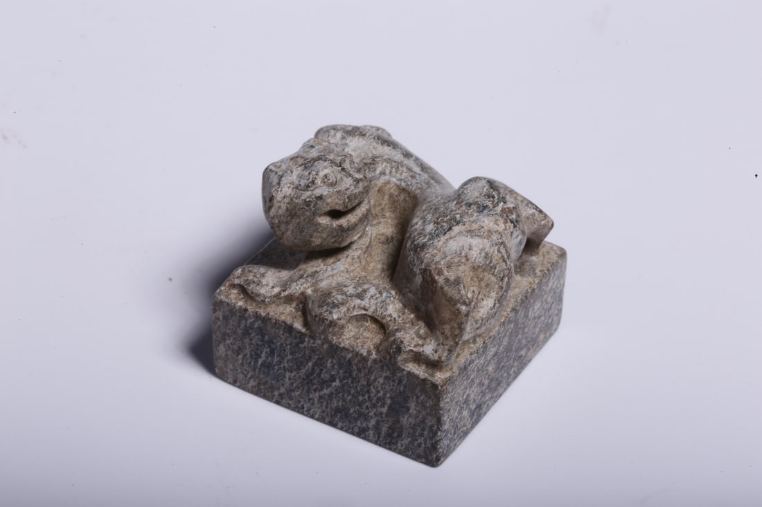 An Archaic Jade Seal: An Archaic Jade Seal. Dimensions: 0.91" x 0.91" x 0.87". Weight: 0.05lbs.