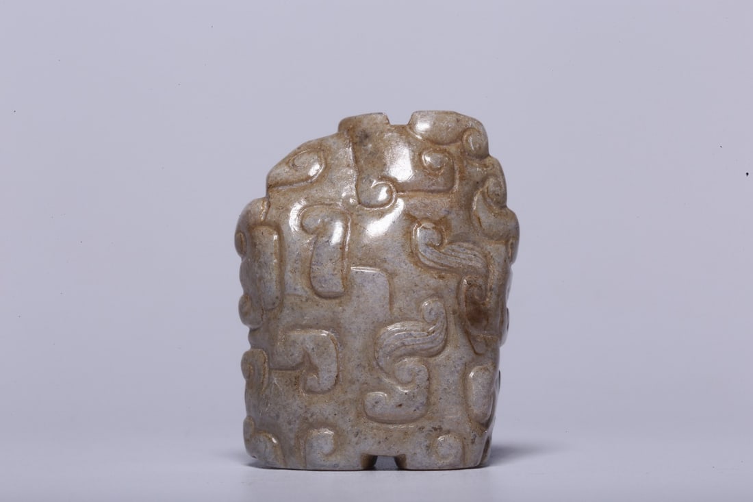 An Archaic Jade Ornament: An Archaic Jade Ornament. Dimensions: 1.18" x 0.59" x 1.50". Weight: 0.06lbs.