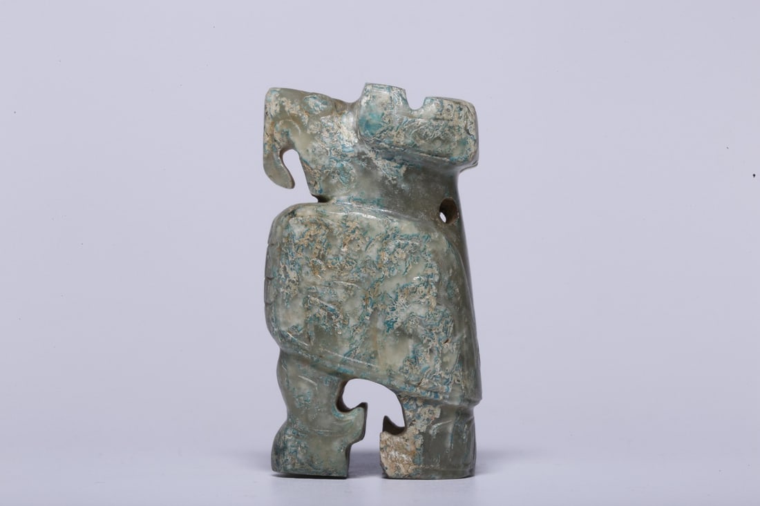 An Archaic Jade Owl Ornament: An Archaic Jade Owl Ornament. Dimensions: 1.18" x 0.79" x 2.09". Weight: 0.11lbs.