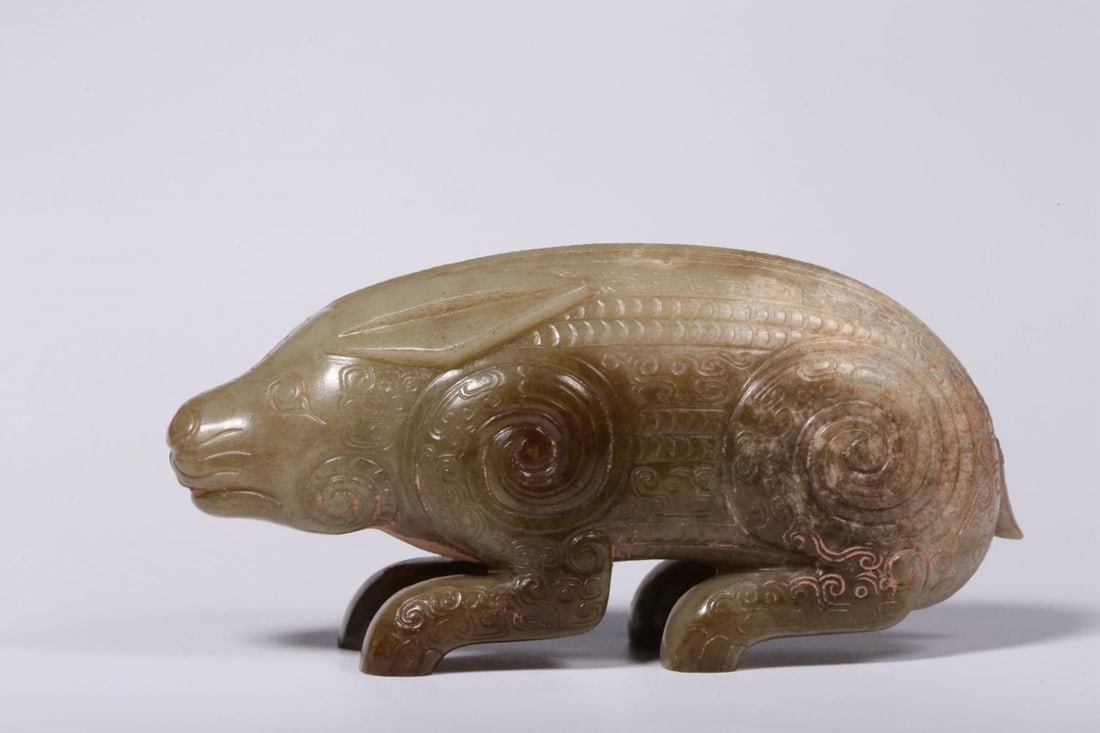 An Archaic Jade Rabbit Ornament: An Archaic Jade Rabbit Ornament. Height: 2.17"; Length: 5.12"; Width: 1.38". Weight: 0.99lbs.