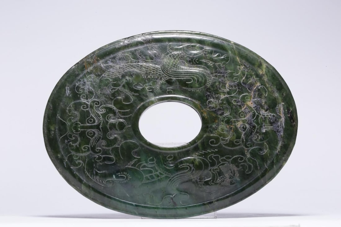 A Hetian Jade Bi Disc: A Hetian Jade Bi Disc. Dimensions: 6.57" x 4.92" x 0.51". Weight: 1.09lbs.