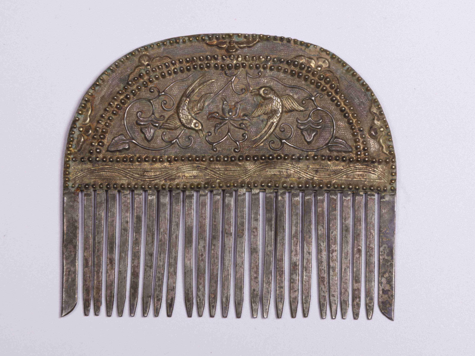 A Silver Comb: A Silver Comb. Dimensions: 4.06" x 3.54" x 0.30".