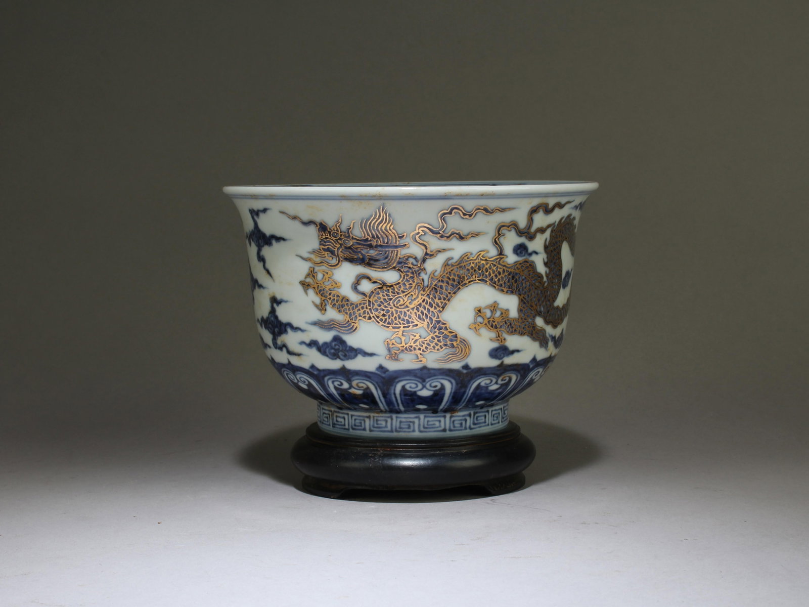 A Porcelain Bowl: A Porcelain Bowl. "XuanDe" mark. Comes with a wooden stand. Dimensions: 4" X 6.2"