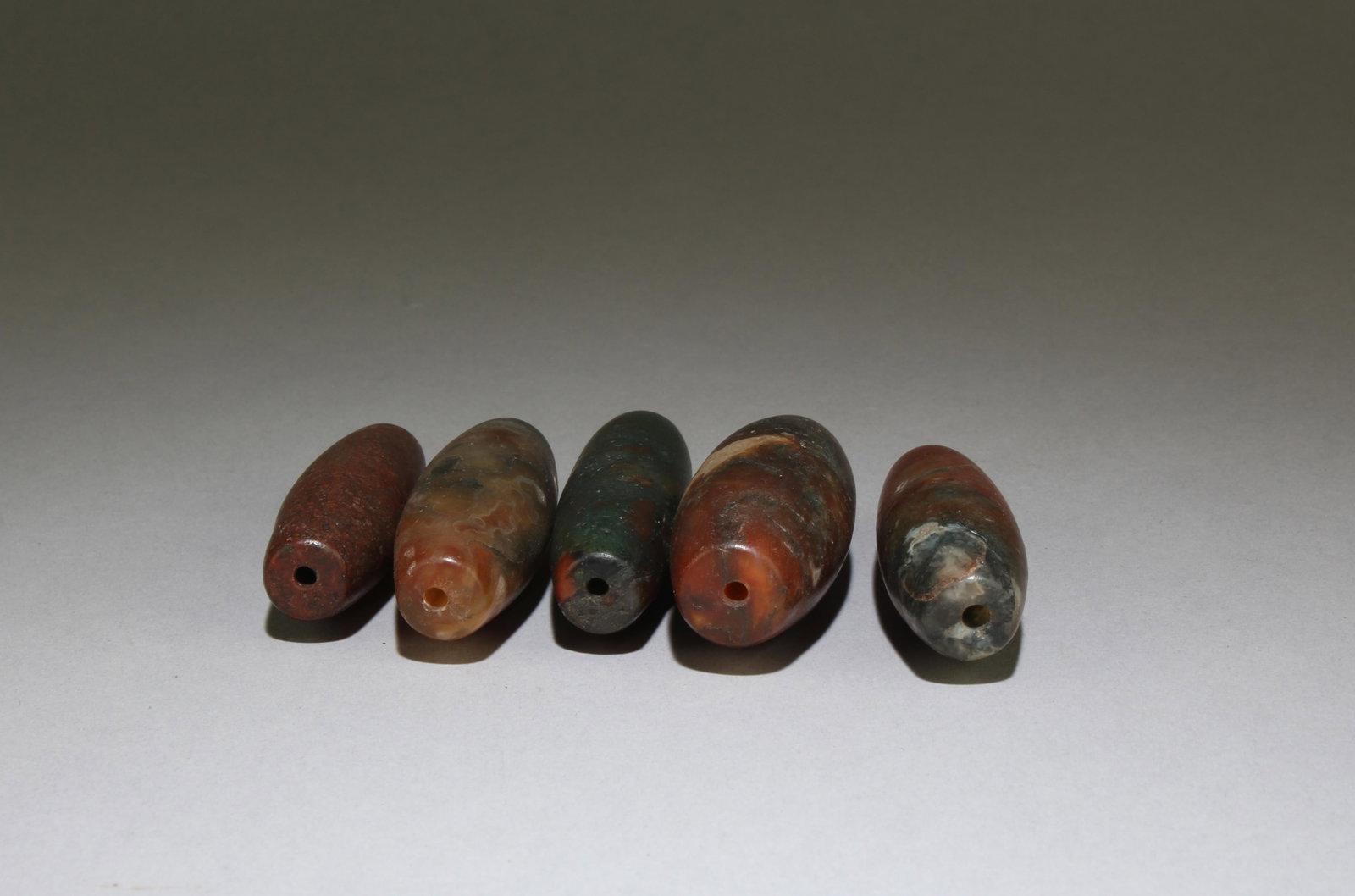 A Group of Four Loose Dzi bead: Length: 2.3''