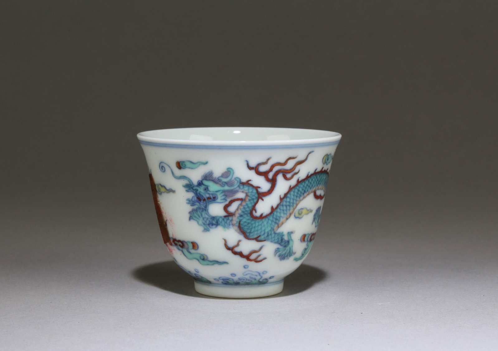 A Doucai Dragon Porcelain Teacup: A Doucai Dragon Porcelain Teacup.'Yongzheng' mark at base. Dimensions: 2.6" X2"