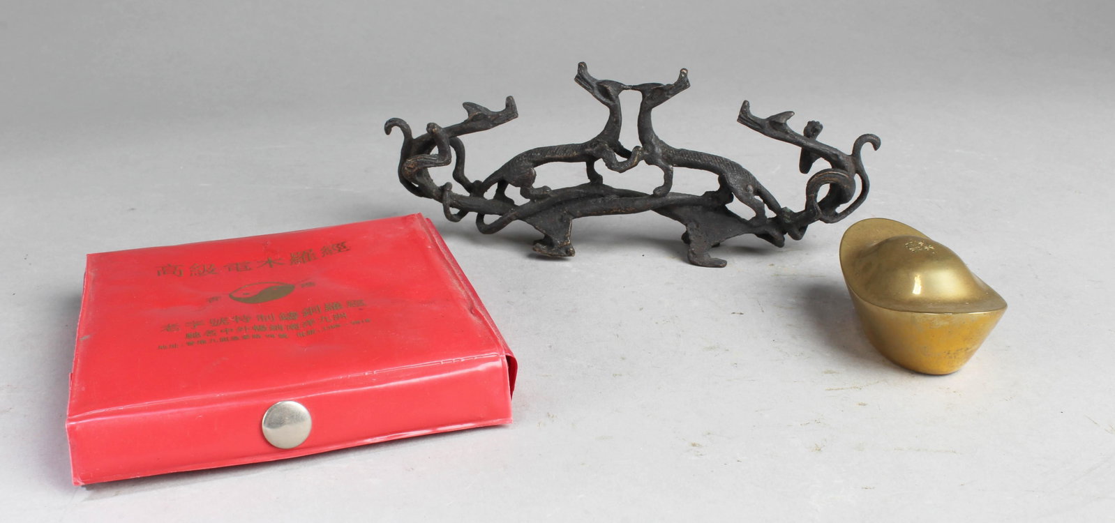 A Goup of Three Ornamet: A Goup of Three Ornamet consisting one ingot, one metal ornament and one feng shui compass ('luo pan'). Length: 7", 3", 4.5"