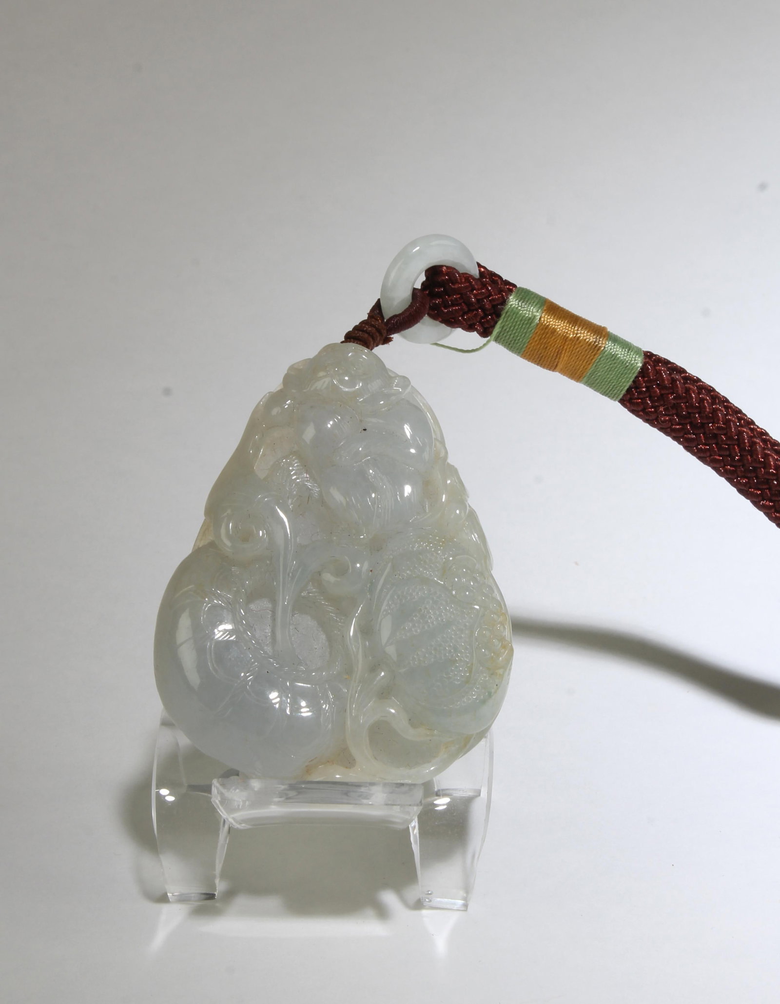 A Jadeite Jade Pendant: A Jadeite Jade Pendant, comes attached to a cord string. Height: 2.25"
