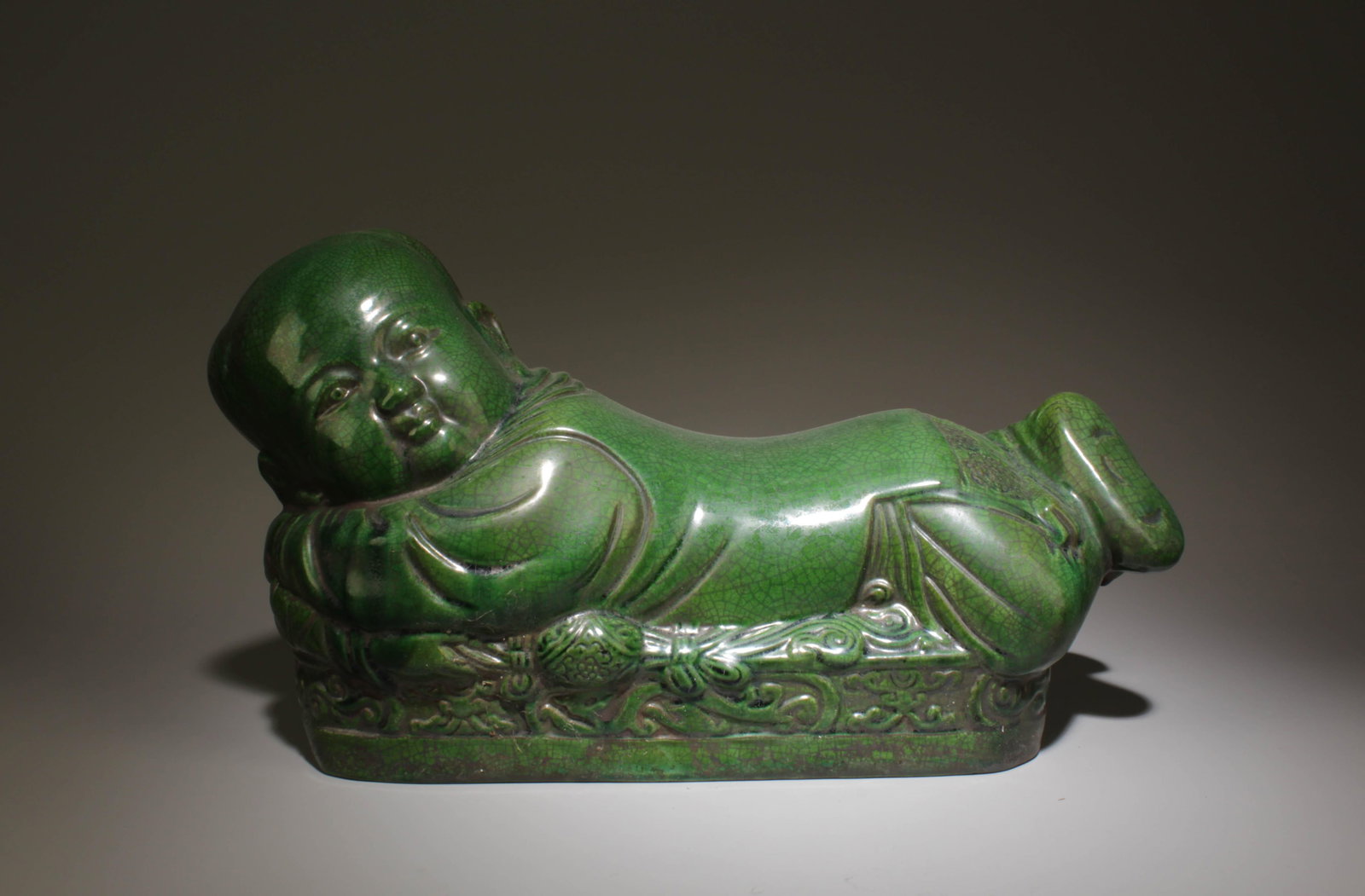 A Green Porcelain Pillow: A Green Porcelain Pillow. Dimensions: 13.5" x 5.5" x 7.2".