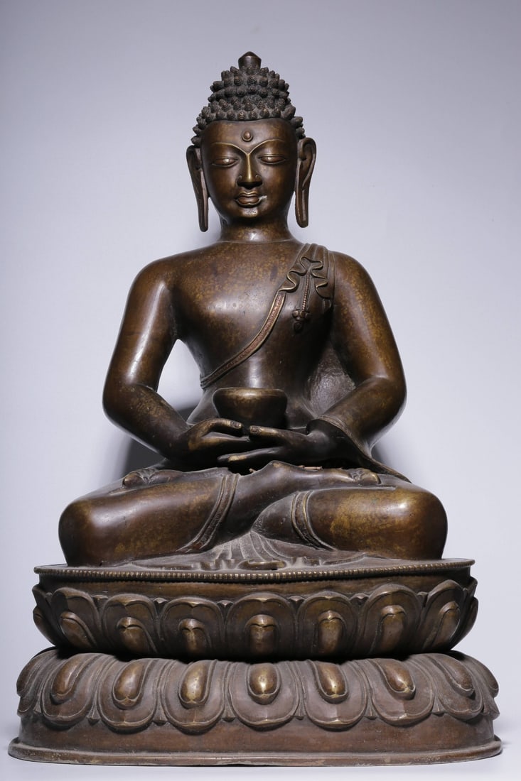 A Bronze Shakyamuni Buddha Statue: A Bronze Shakyamuni Buddha Statue. Height: 24.41in; Length: 16.34in; Width: 12.80in; Weight: 47.95lb.