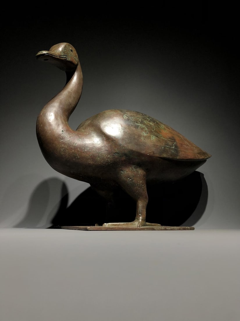 A Bronze Duck Figurine: A Bronze Duck Figurine. Diameter: 23.23in; Width: 9.84in; Height: 18.11in; Weight: 39.68lb.