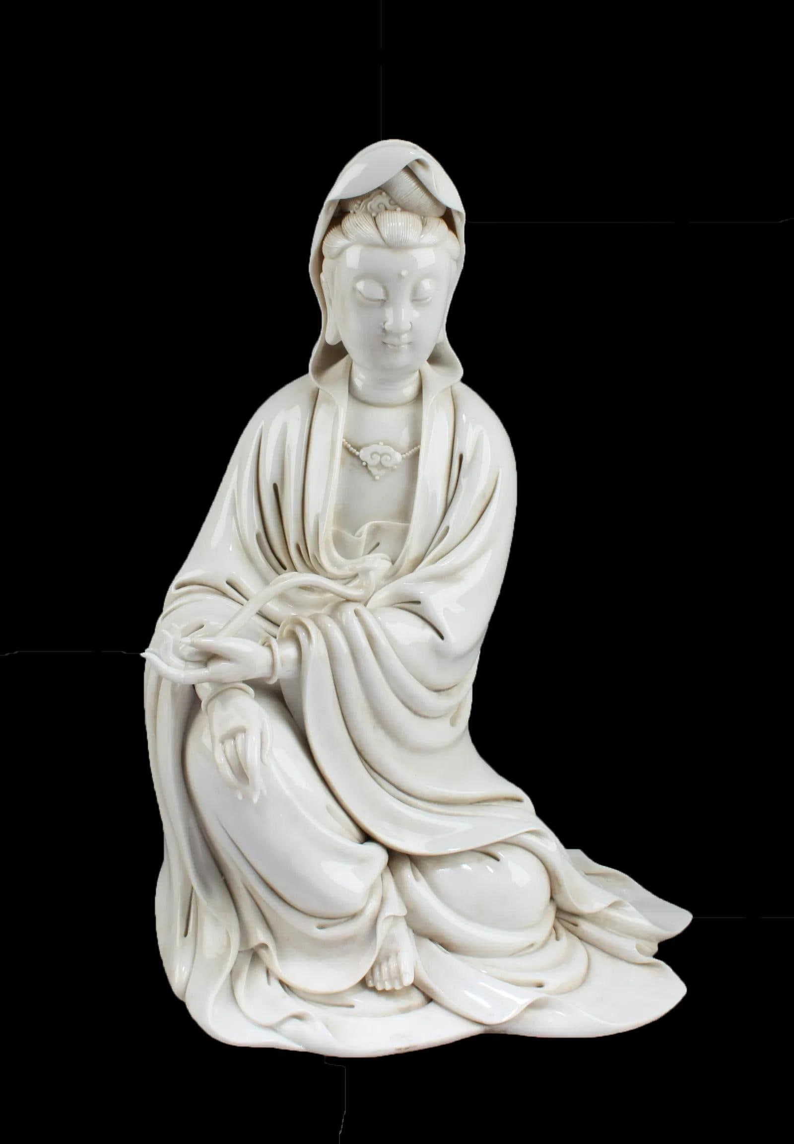Chinese Blanc De Chine Seated Guanyin Statue: Chinese Blanc De Chine Seated Guanyin Statue. Seal mark at back of figurine. Height: 14"