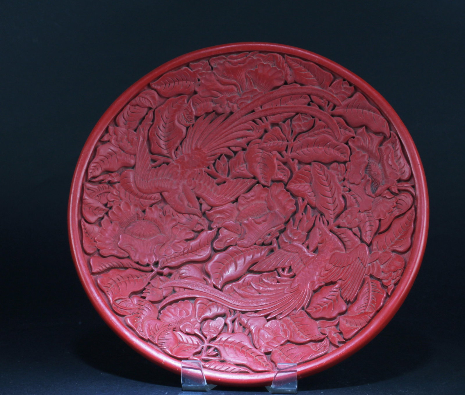 A Round Cinnabar Lacquer Plate: A Round Cinnabar Lacquer Plate. 'QianLong' mark at base. Dianmeter: 11.7"