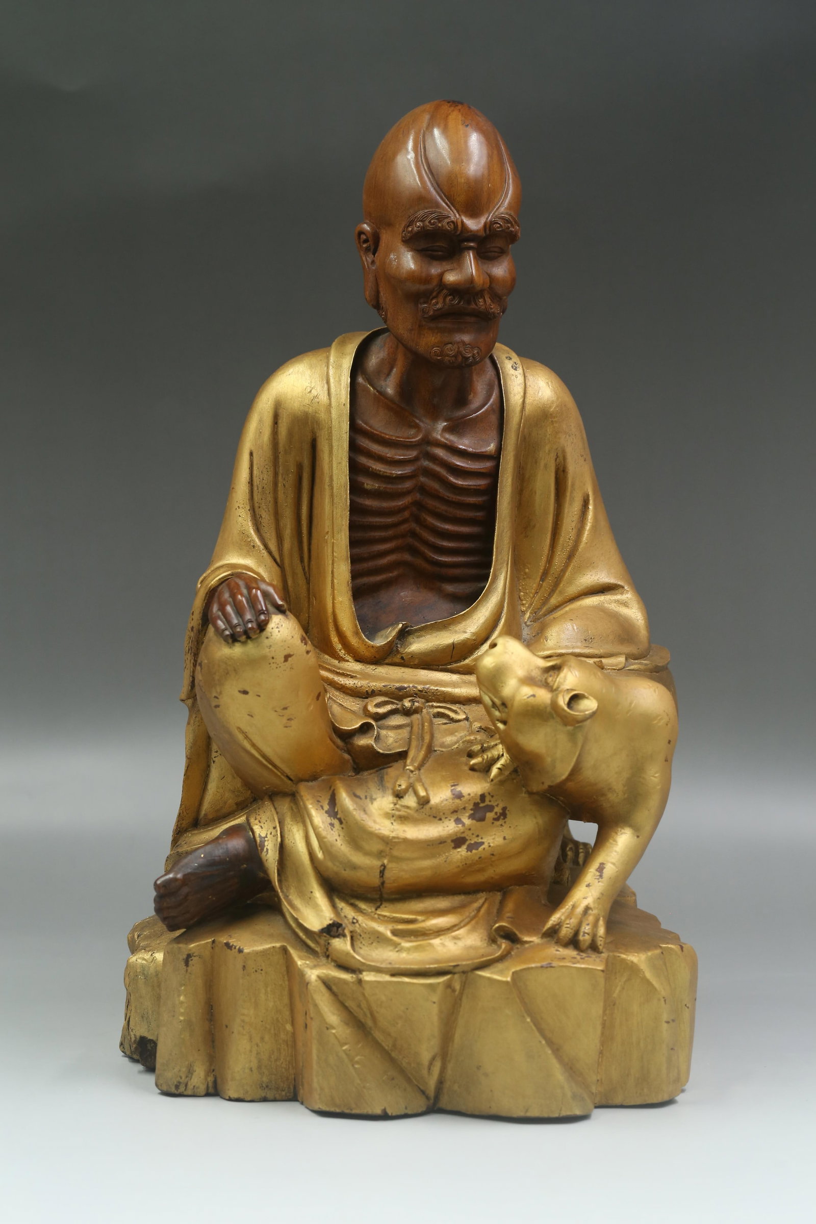 A Gold Lacquered Dharma Statue Carved From Boxwood: A Gold Lacquered Dharma Statue Carved From Boxwood. Dimensions: 16.5" x 9.5"