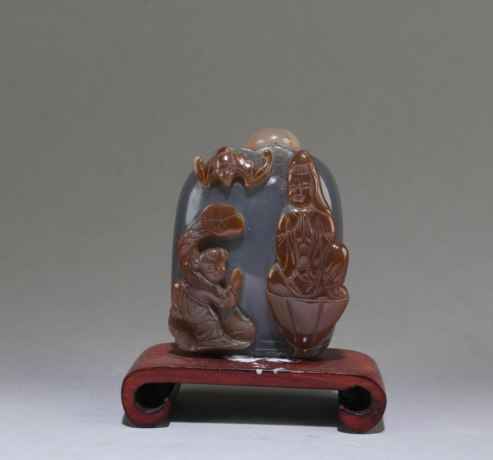 An Agate Snuff Bottle: An Agate Snuff Bottle. Comes with base. Height: 2.7" Length: 2.2"