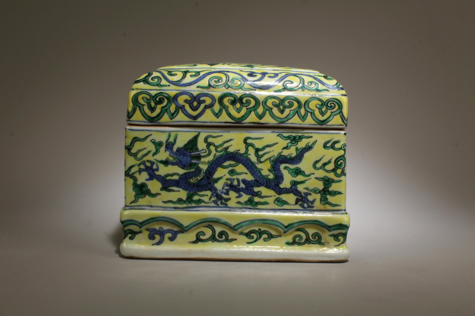 A Blue, Green, and Yellow Container with Lid: A Blue, Green, and Yellow Container with Lid. Dimension: 6" x 5.25".