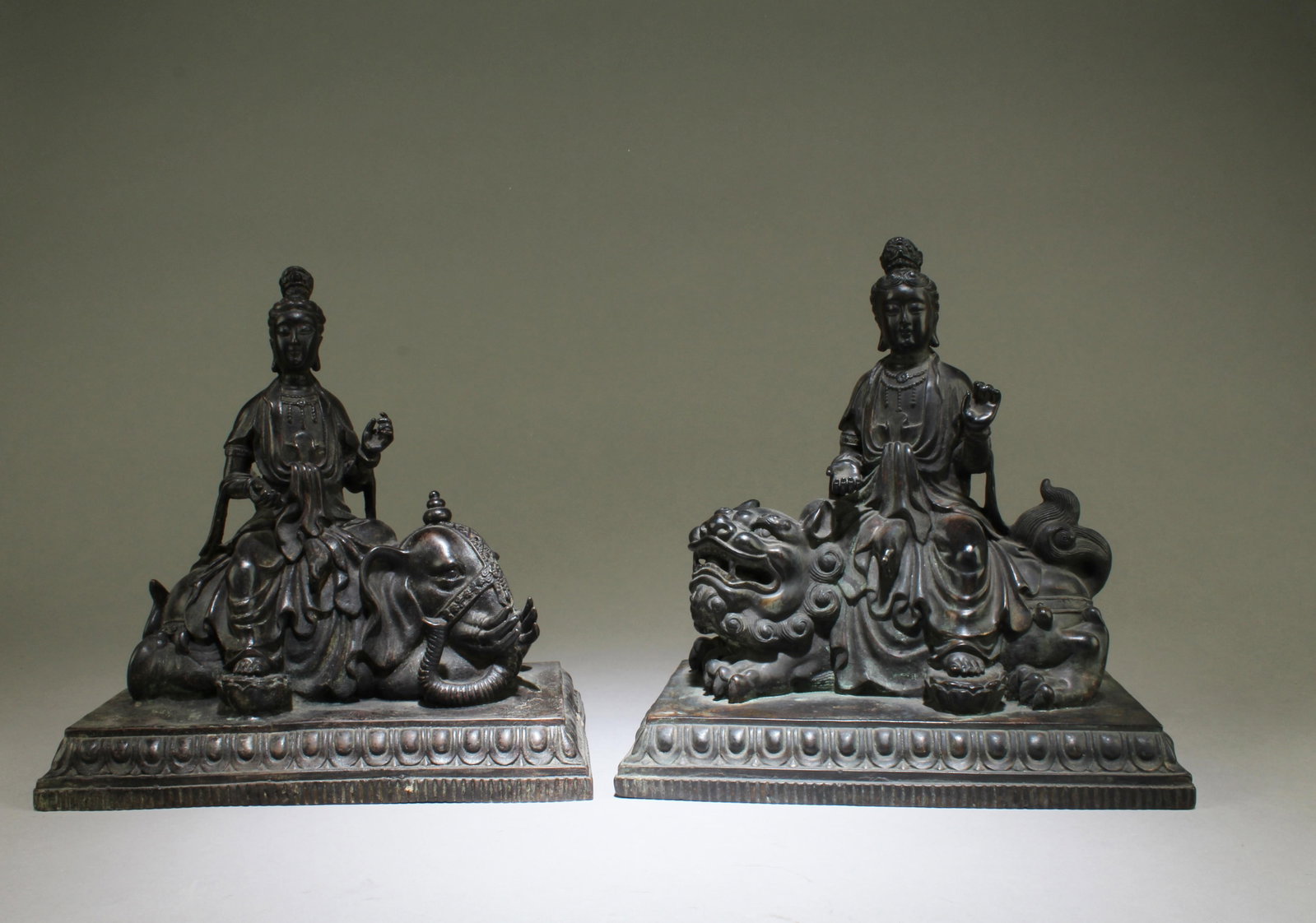 A Pair of Bronze Guanyin Seated: A Pair of Bronze Guanyin Seated on Lion and Elephant. Dimensions: 9" X 9" X 5.5" (one piece)