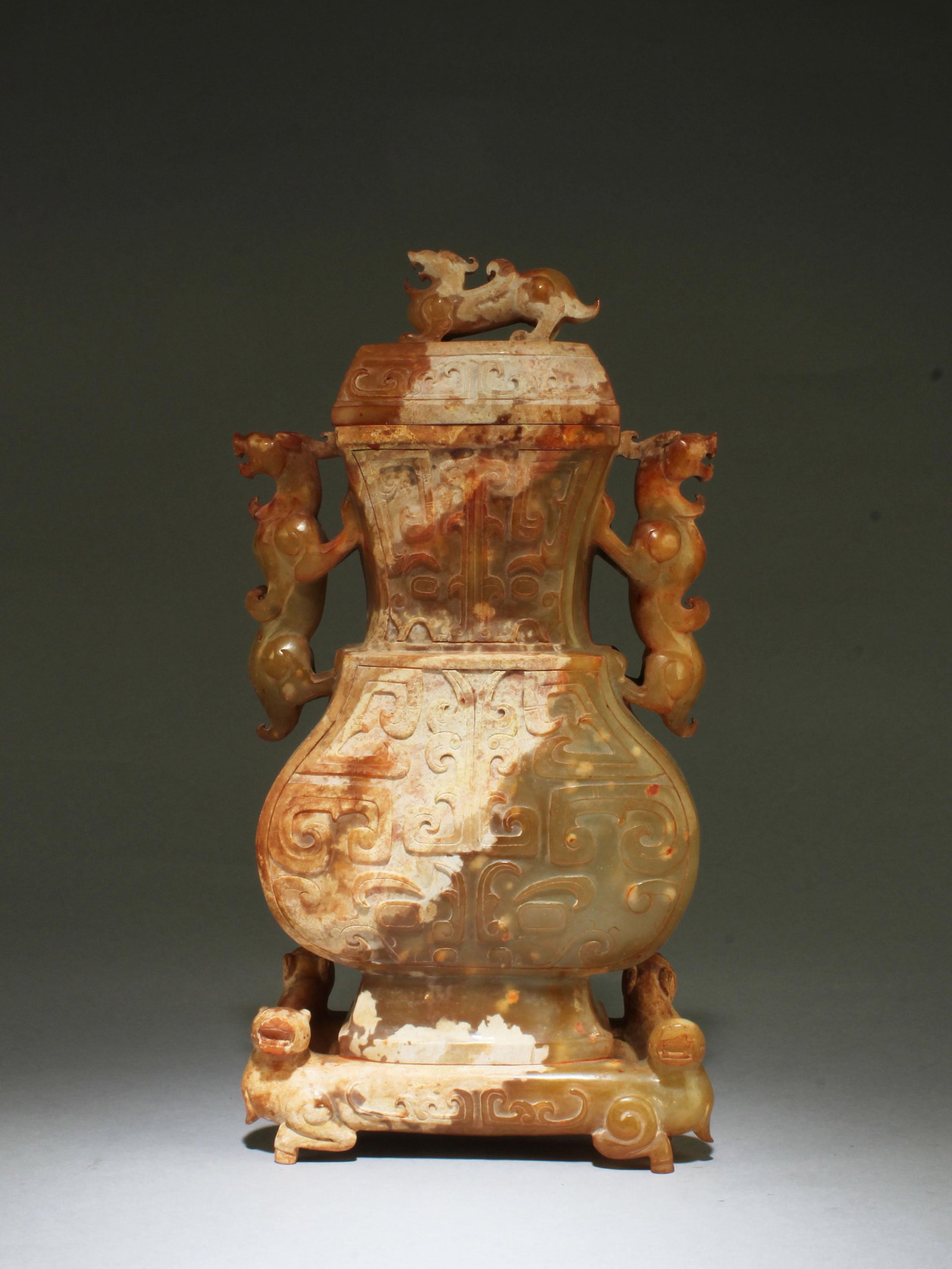 A Carved Jade Vase: A Carved Jade Vase with lid. Height: 11" Length: 7.5"