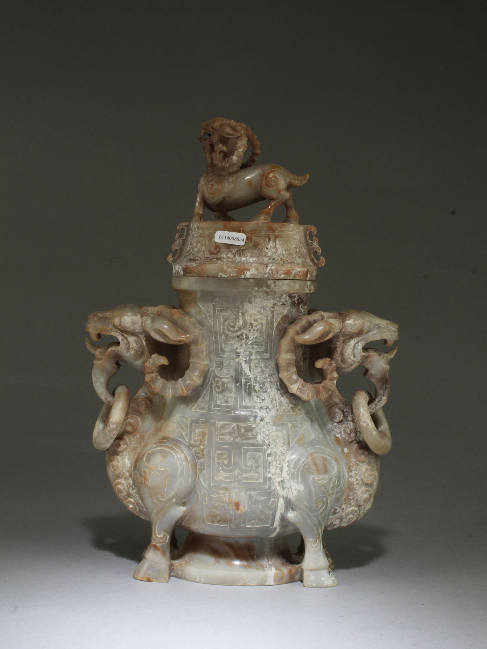 A Carved Jade Vase: A Carved Jade Vase with lid. Height: 12" Length: 8.25"
