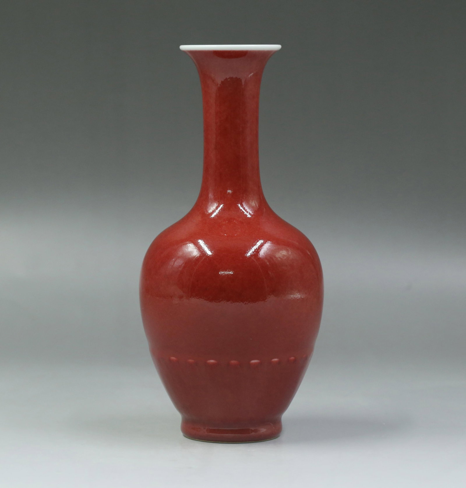 A Red-Glazed Porcelain Vase: A Red-Glazed Porcelain Vase. 'KangXi' mark at base. Height: 8.46"
