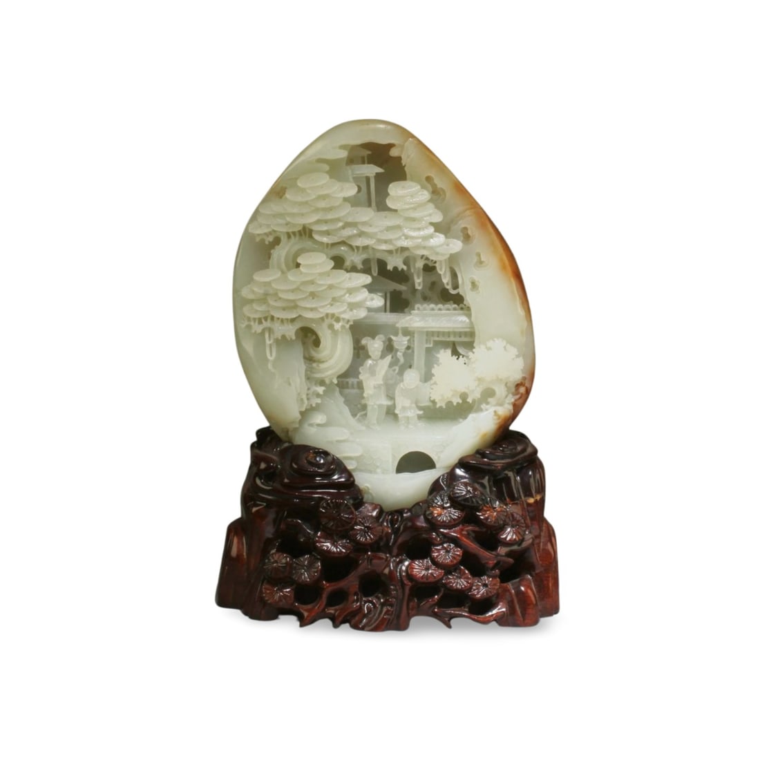 A Chinese Jade Carved Ornament: A Chinese Jade Carved Ornament with russet suffusions. Height: 7.5"