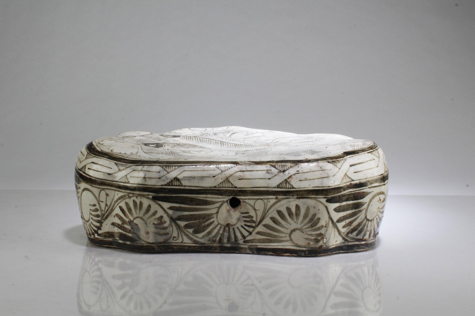 A Cizhou Pillow: A Cizhou Pillow. Length: 11" Width: 8.5" Height: 3.5"