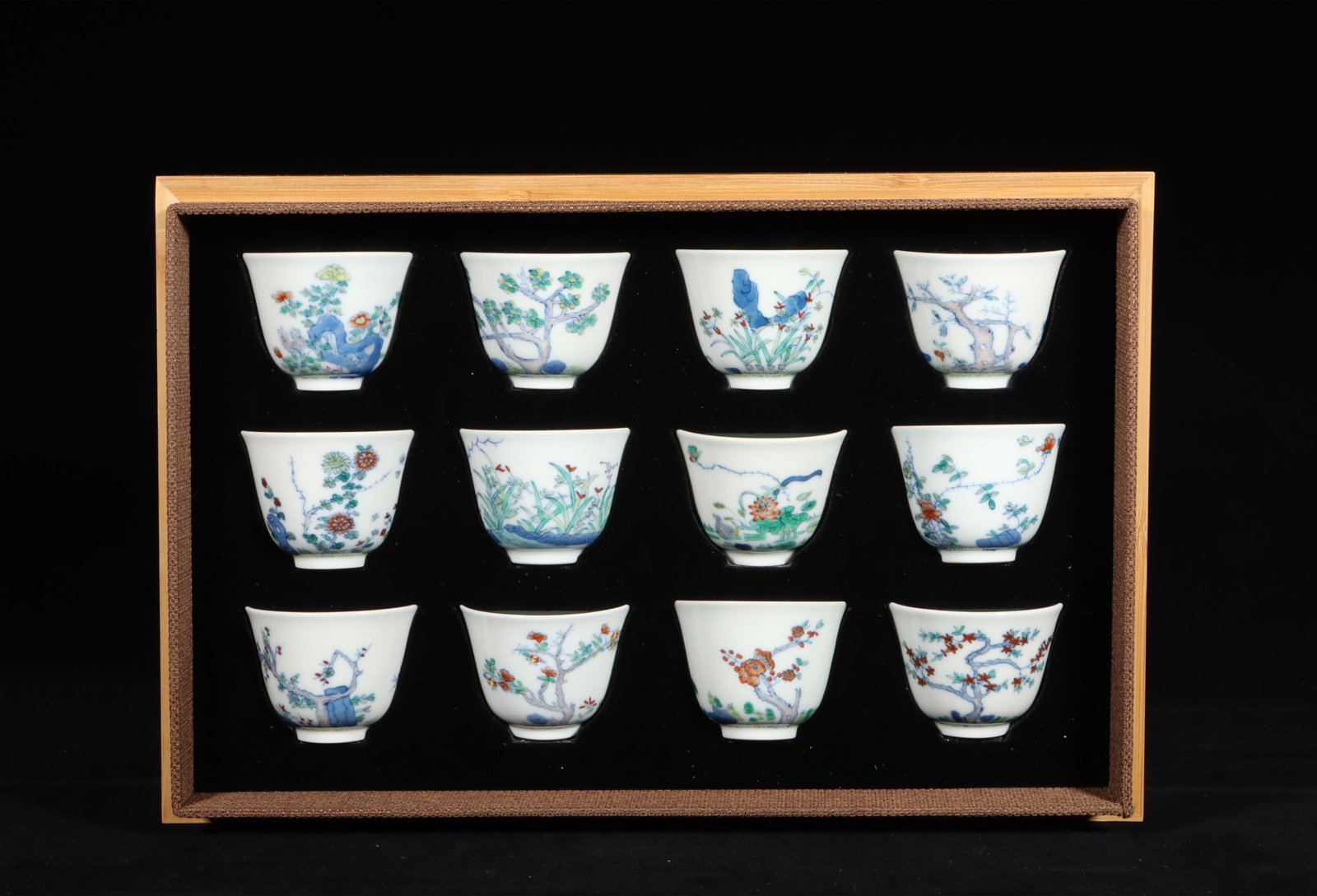 A Group of Twelve Doucai Glazed Cups: A Group of Twelve Doucai Glazed Cups."KangXi" mark at base, Height: 2.17in; Diameter: 2.56in.