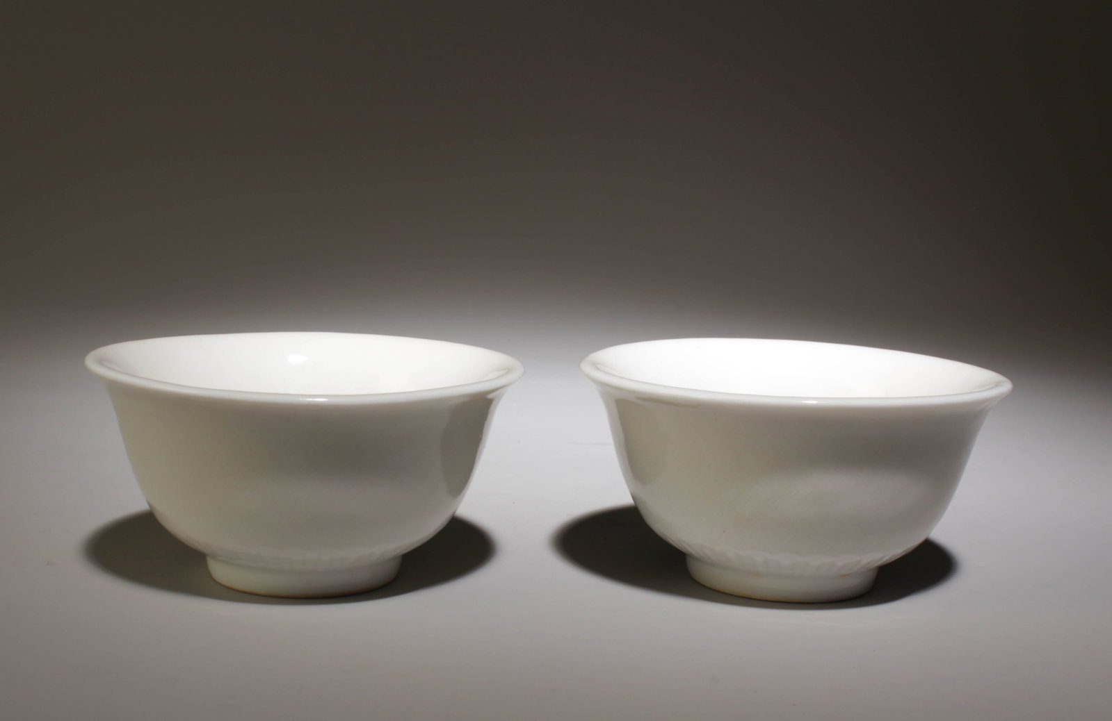 A Pair of White Glazed Cups: A Pair of White Glazed Cups. "YongLe" Mark at Base. Dimensions: 3.25" x 1.75".