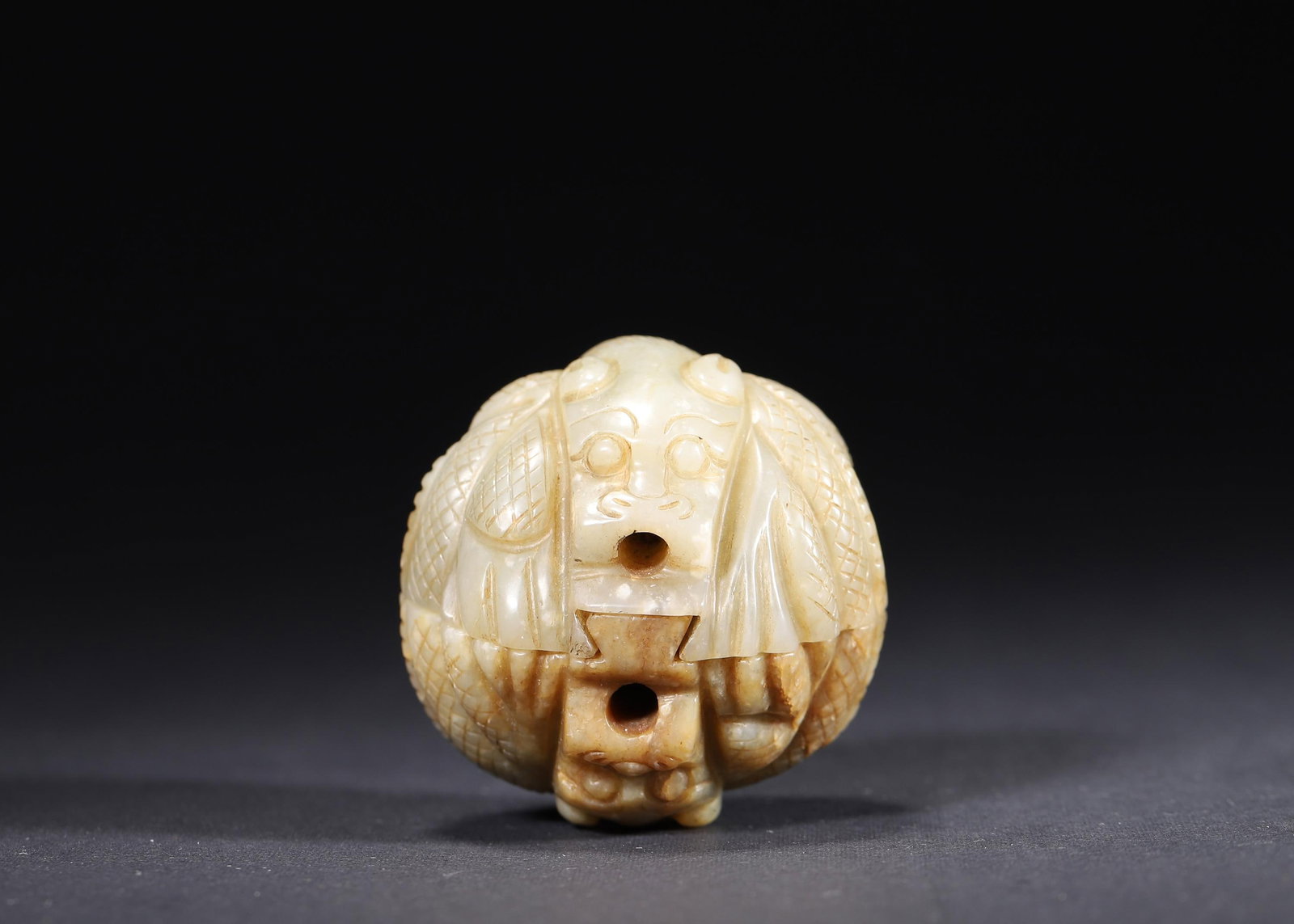 MING DYNASTY PAIR OF PALE GREEN JADE BEAST-FACE BELT BUCKLES: 1.89" (4.8cm) | 0.313lb (142g)A fine pair of Ming Dynasty pale green jade belt buckles, carved with imposing beast-face motifs in high relief. Featuring natural russet inclusions and precise back slot