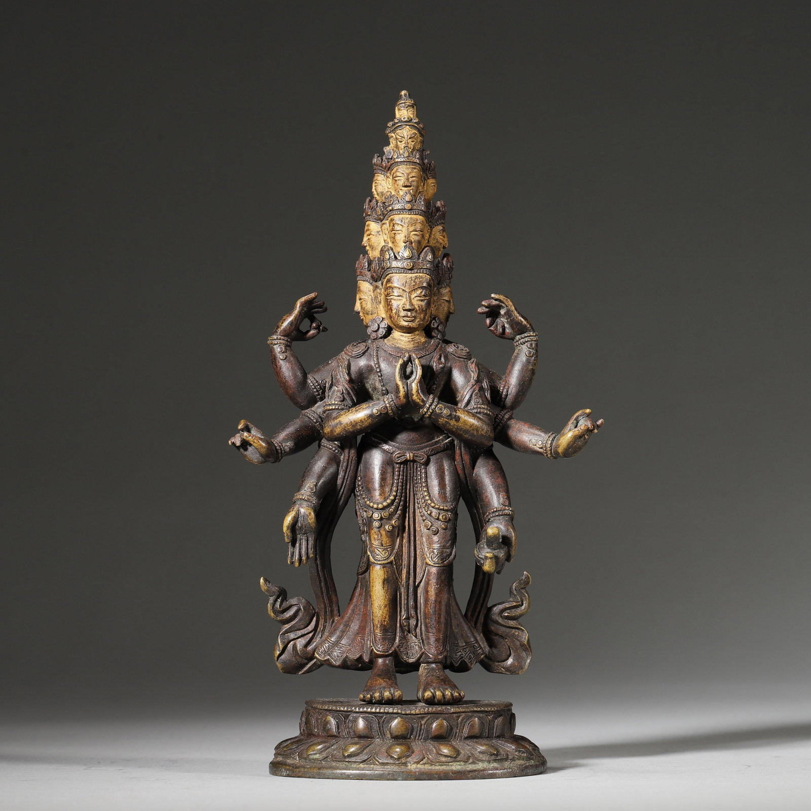 A GILT-BRONZE ELEVEN-HEADED EIGHT-ARMED AVALOKITESHVARA STANDING STATUE, QING DYNASTY (18TH-19TH: Diameter: 10cm (3.94in) H: 19cm (7.48in) Weight: 585g (1.29lb)This 18th-19th century Qing gilt-bronze statue features an Eleven-Headed Eight-Armed Avalokiteshvara, with exquisite craftsmanship, profou