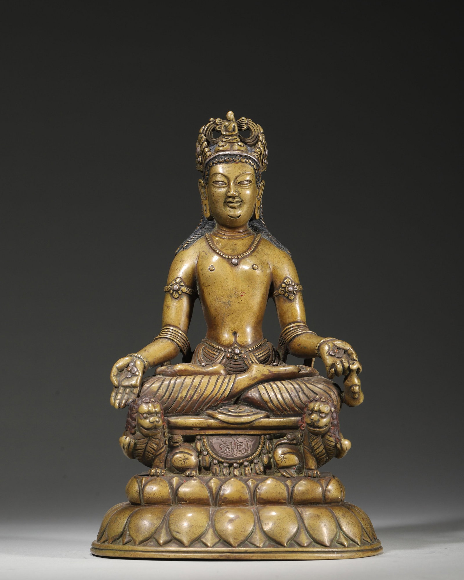 A COPPER ALLOY FIGURE OF JAMBHALA (YELLOW WEALTH DEITY) WITH SILVER INLAY AND INSCRIBED BASE,: 5.12in x 4.72in x 8.27in (13.0cm x 12.0cm x 21.0cm), 4.502lb (2042.0g)This 15th-16th century Himalayan copper Jambhala, seated on a double-lion throne, features silver inlay and inscribed base. With s