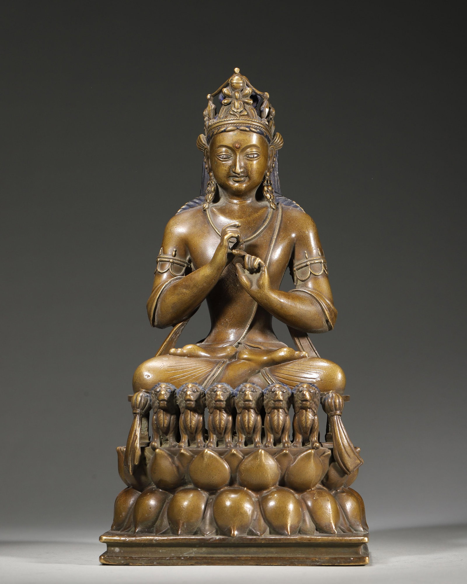 15TH-16TH CENTURY COPPER STATUE OF VAIROCANA: 5.12" x 4.33" x 9.84" (13cm x 11cm x 25cm) | 3.67lb (1663g)This 15th-16th century Tibetan Buddhist statue depicts Vairocana, cast in copper, with wisdom fist mudra. It features a six-lion lotus throne