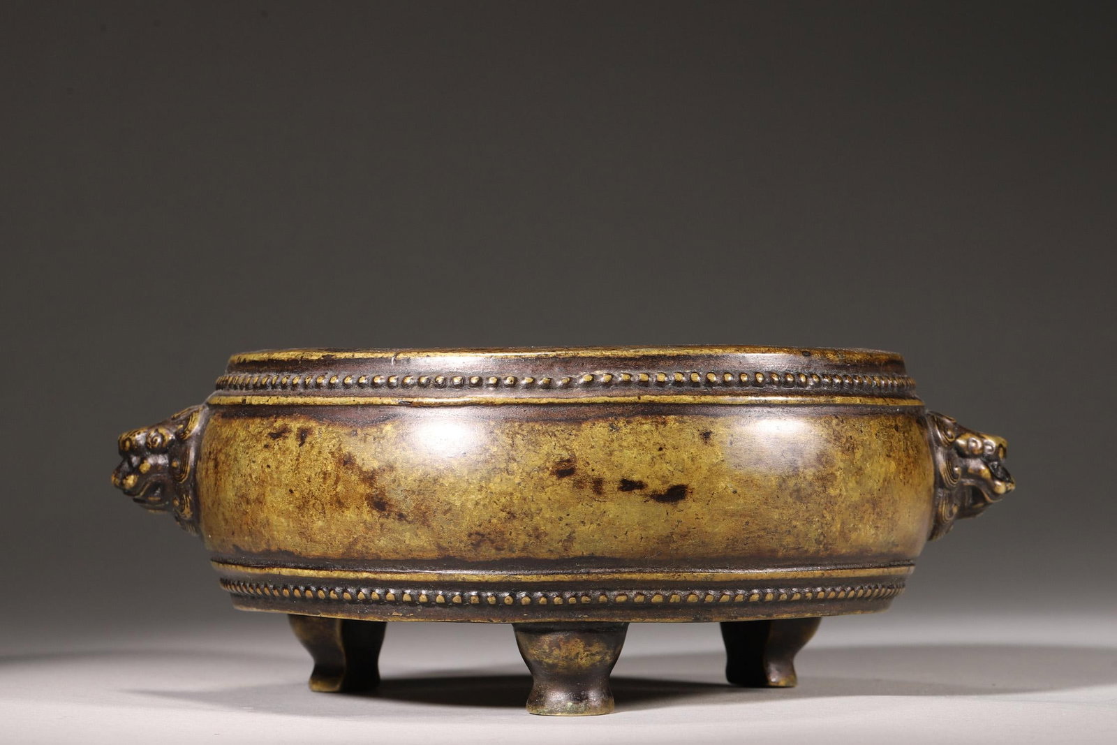 A DRUM-SHAPED BRONZE INCENSE BURNER WITH LION HANDLES, QING DYNASTY (1 of 8)