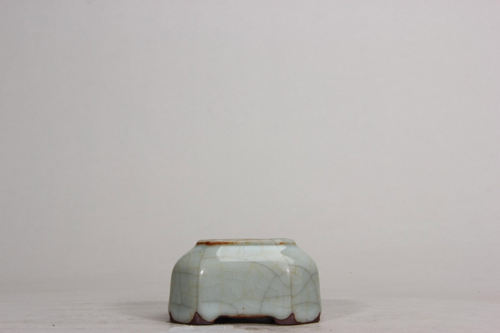A GE-TYPE GLAZE HEXAGONAL WATER POT, YONGZHENG PERIOD, QING DYNASTY: H 3.9cm (1.54 in); Cal 4.1cm (1.61 in)This Yongzheng period Ge-type glaze hexagonal water pot features an elegant form. Covered in light blue glaze with natural "gold and iron thread" crackles, it has