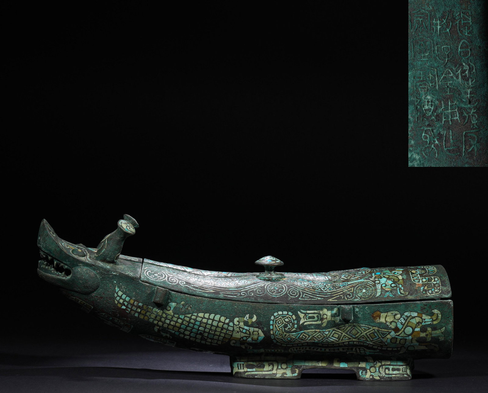 BRONZE INLAID WITH GOLD AND SILVER AND TURQUOISE DRAGON-SHAPED RITUAL VESSEL OF THE HAN DYNASTY: H:14cm(5.51in)W:40cm(15.75in)Weight:4570g This Warring States to Han Dynasty bronze ritual vessel, shaped like a dragon-headed beast with exquisite gold-silver inlay, turquoise scale patterns, and a l