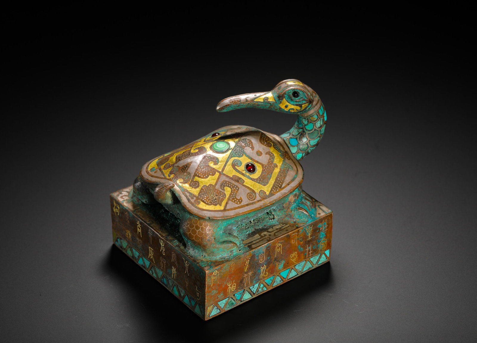 BRONZE SQUARE SEAL WITH A TURQUOISE TURTLE-BIRD KNOB FROM THE WARRING STATES PERIOD: H:8cm (3.15in) W:10cm (3.94in) Weight:880g (1.94lb)A Warring States square bronze seal with turtle-bird knob inlaid with gold and turquoise. Square seal base topped by a composite knob of turtle body 