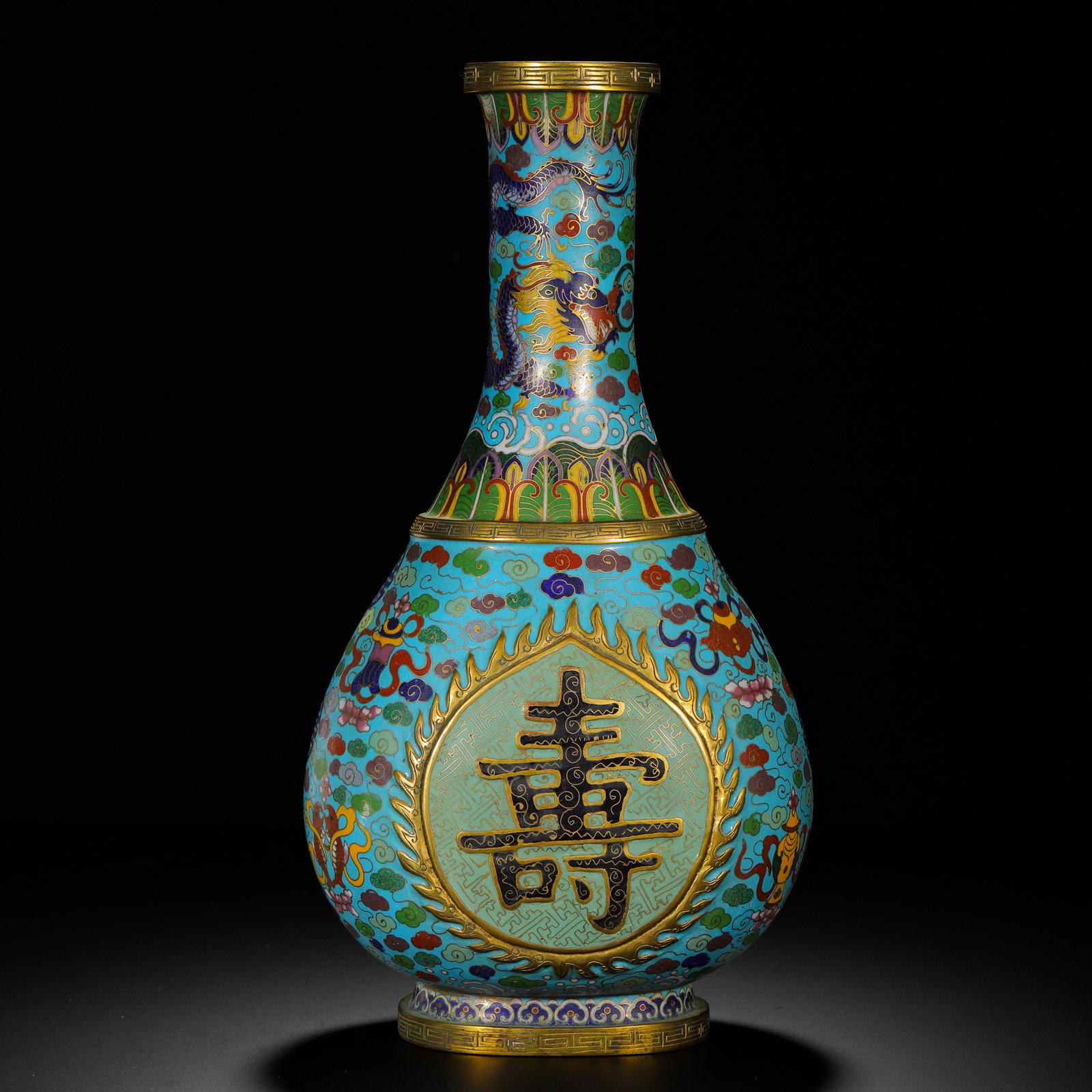 QING DYNASTY COPPER CLOISONNE ENAMEL "LONGEVITY" CHARACTER DRAGON PATTERN LONG NECK VASE: H:26cm (10.24in) W:18cm (7.09in) Weight:2040g (4.50lb)Features a large "shou" (longevity) character within a cartouche, surrounded by the Eight Auspicious Symbols and clouds, symbolizing "boundless lo