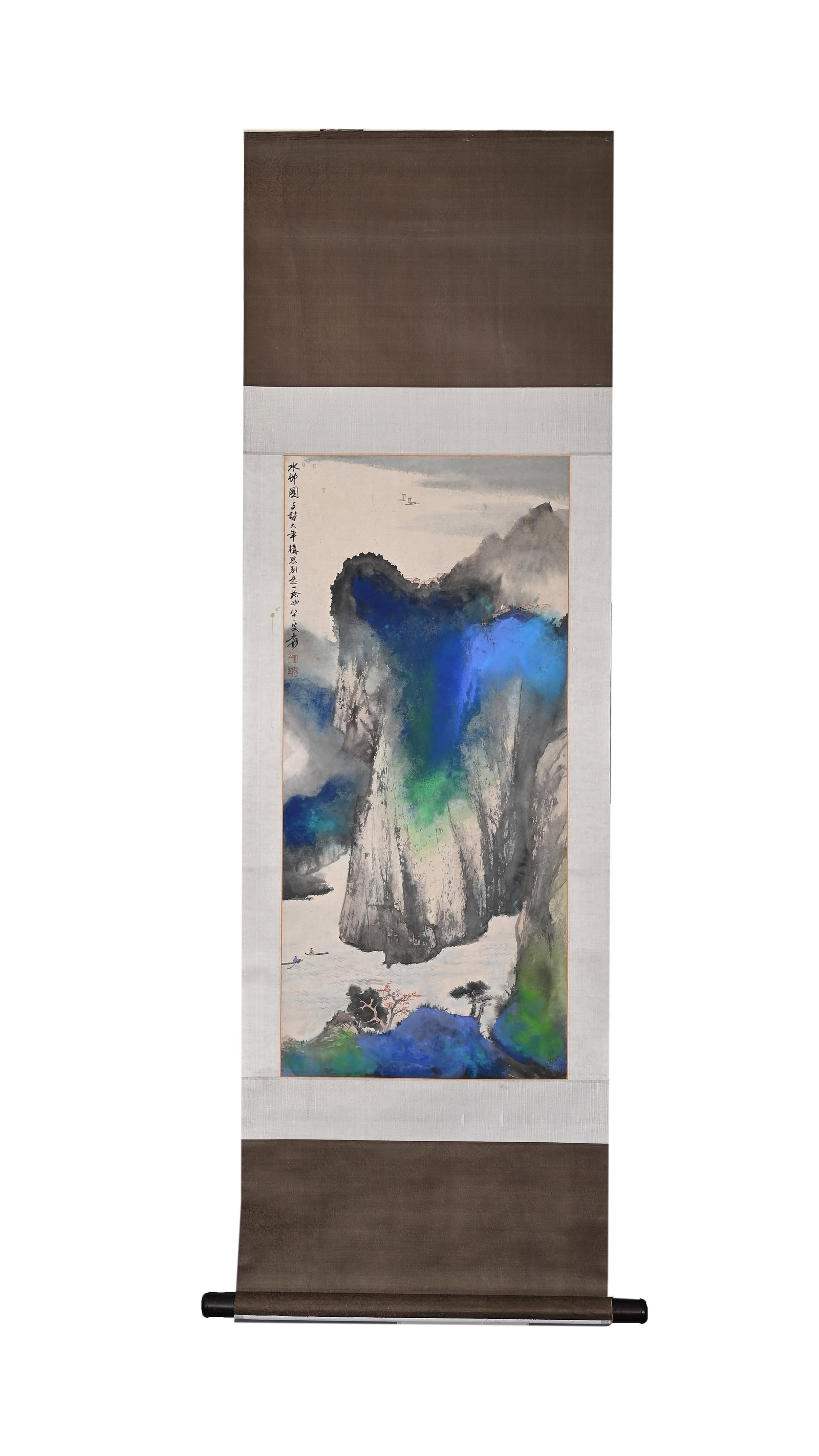 ZHANG DAQIAN (1899-1983) A VERTICAL SCROLL OF CLOUDS SURGING OVER THE XIJIANG RIVER: H:97cm(38.19in) W:44cm(17.32in)A vertical splashed-color landscape painting on paper of modern times in the style of Zhang Daqian, depicting towering Three Gorges peaks with rich blue and green splash