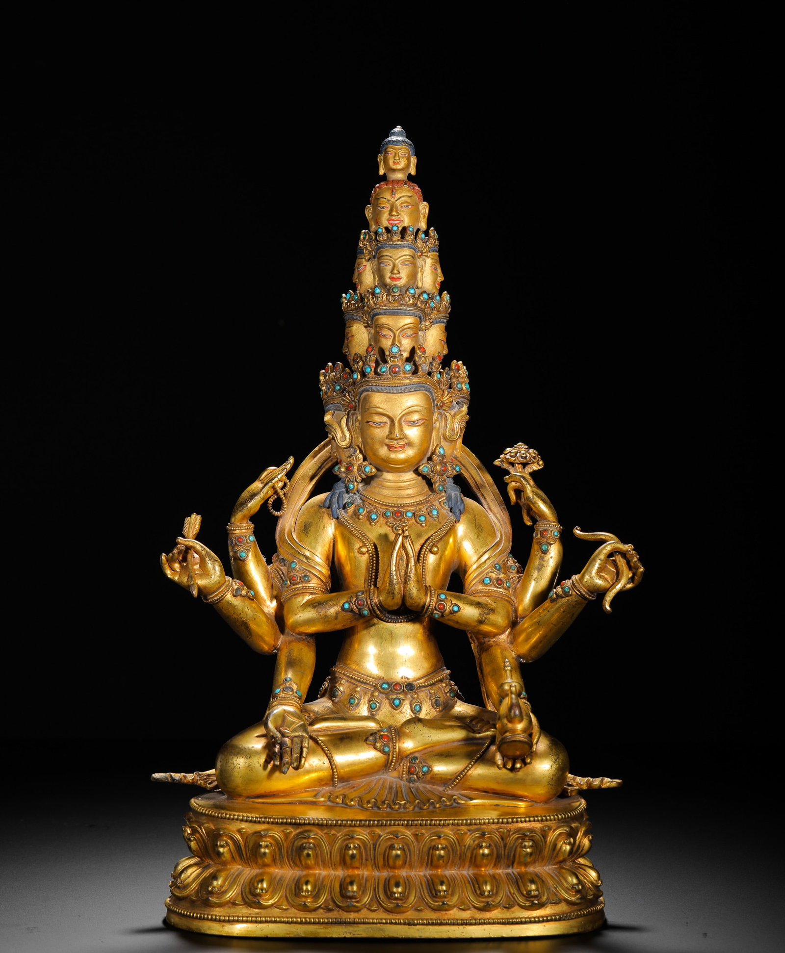 A GILDED BRONZE STATUE OF GUANYIN BODHISATTVA WITH EIGHT ARMS AND ELEVEN FACES FROM THE QING DYNASTY: H:38cm (14.96in) W:24cm (9.45in) Weight:5400g (11.90lb)This is a Qing Dynasty gilt bronze seated statue of the eight-armed and eleven-headed Guanyin in the Tibetan Buddhist style, featuring exquisite 