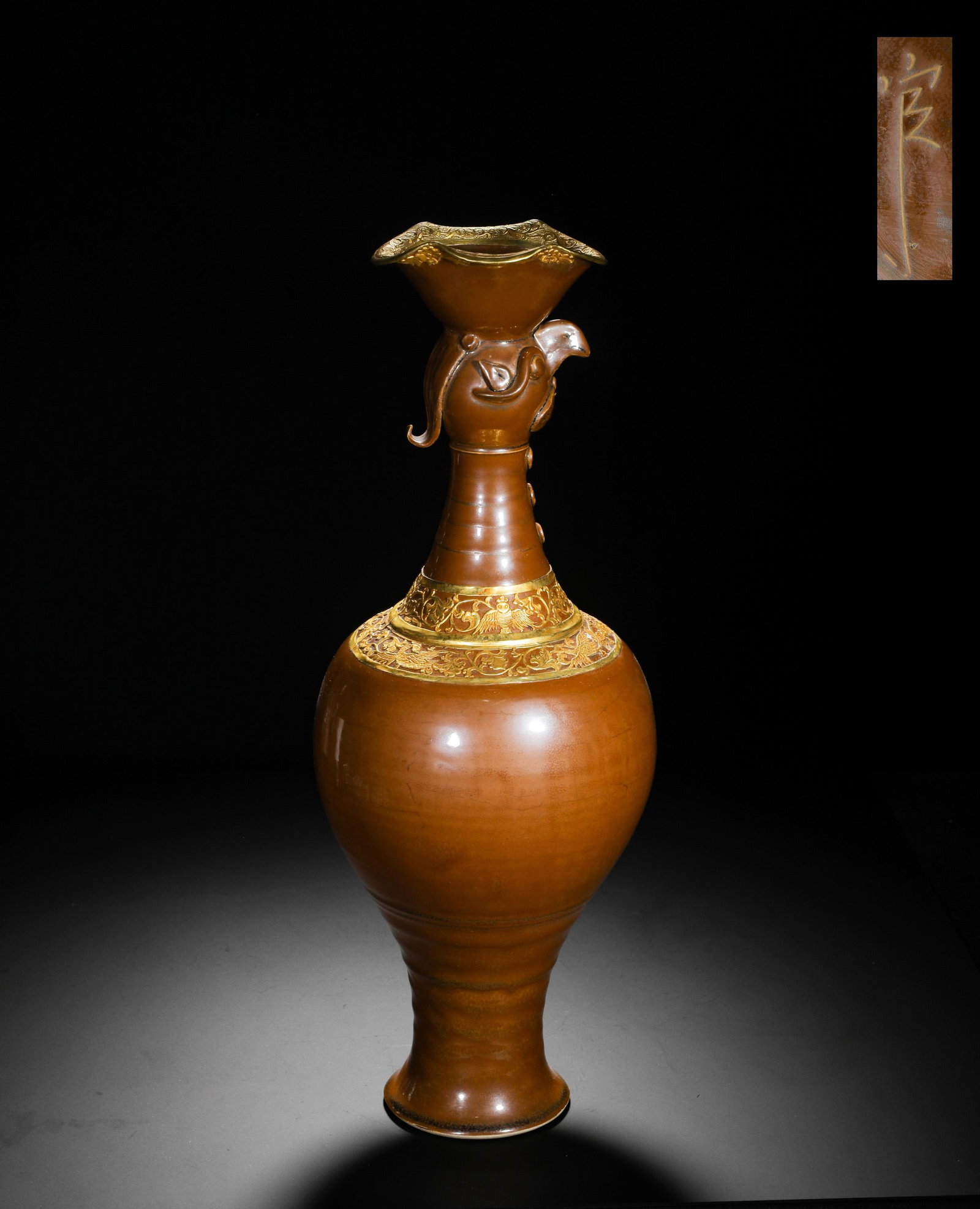 SONG DYNASTY DING KILN SAUCE-GLAZED GILDED PHOENIX-HEAD VASE: H:45cm(17.72in) D:16cm(6.30in) Weight:1470g(3.24lb)This is a rare masterpiece of Song Dynasty Ding Yao persimmon-glazed ware, combining porcelain with precious metal craftsmanship to exude imperial gr