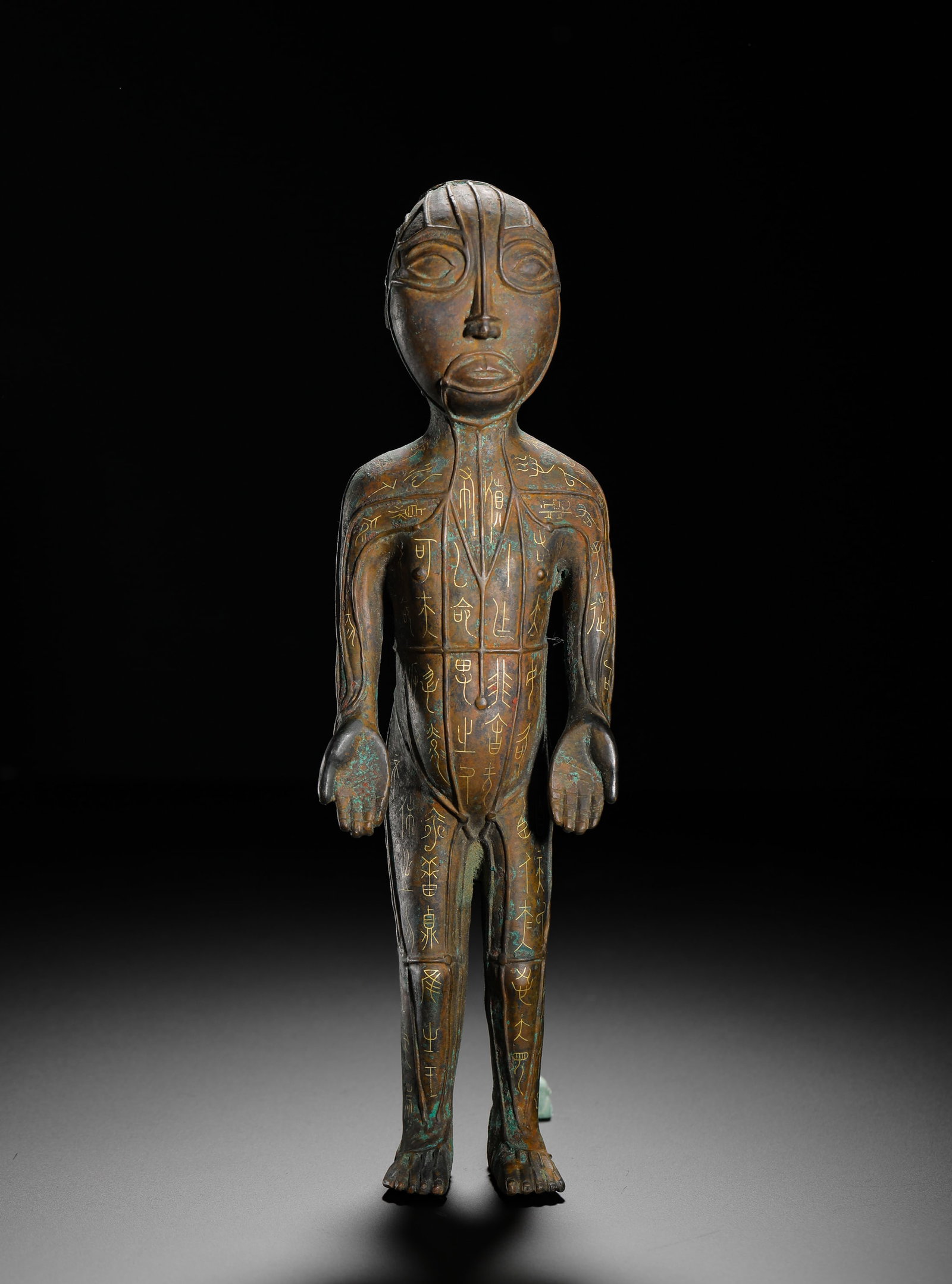 BRONZE ACUPUNCTURE FIGURINES WITH INSCRIPTIONS ON MERIDIANS FROM THE WARRING STATES PERIOD: H:25cm (9.84in) W:7.5cm (2.95in) Weight:920g (2.03lb)Full-cast standing bronze human figure, golden inscriptions mark body meridians & acupoints, ancient TCM acupuncture teaching model.